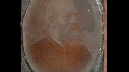 A copper plate with a photographic image of the Rev Oswald Reichel.